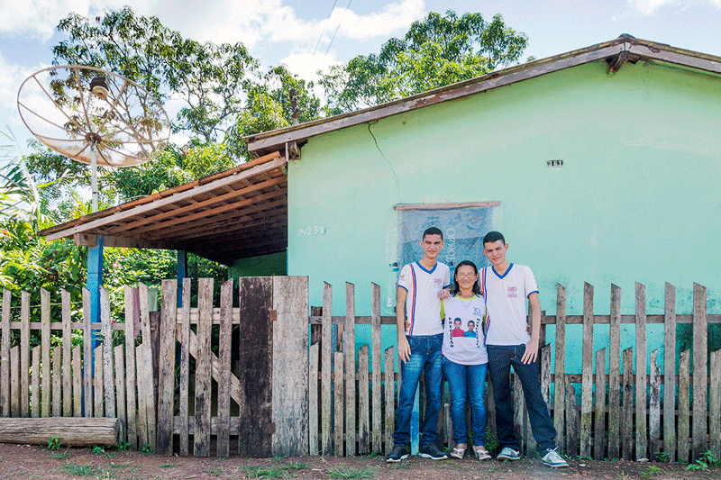 Daniel e João Paulo Pinheiro Melo com a mãe, em frente à casa onde moram em Jacundá